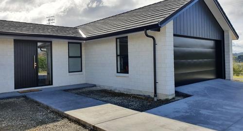 Front Garage Side of House New house requiring a soft warm welcoming entry.