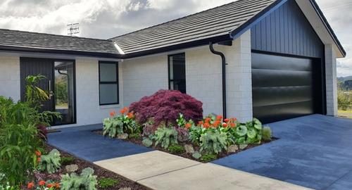Front Garage Side of House Height & colour created with maples & a variety of plants.