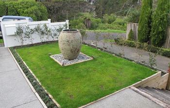 Landscaping Pot Creating a sloping section into a flat section with a water feature.