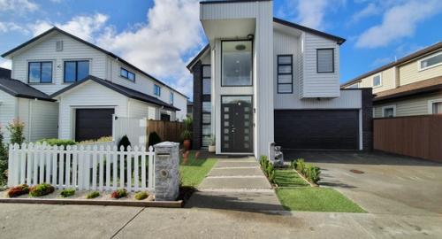 Modern home with a dated entry. To many variety of shrubs and a picket fence that is not in keeping with a modern home. No privacy or security from the public footpath to the front door.